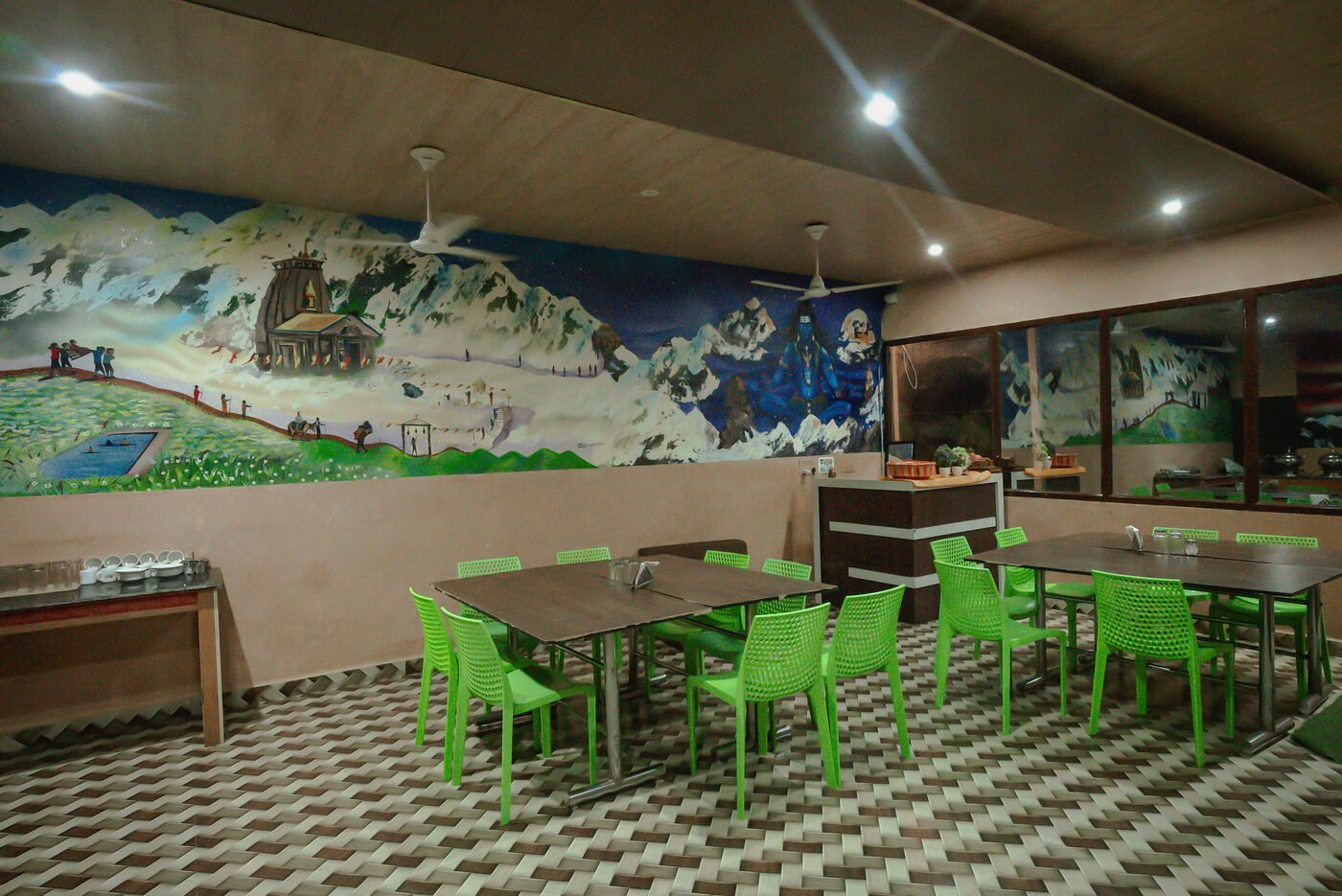 Dining hall at Shersi Heights Resort with mountain mural